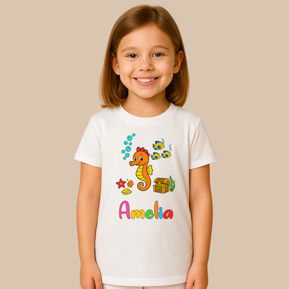 Child wearing a white t-shirt with a colorful seahorse design and the name 'Amelia' on a beige background