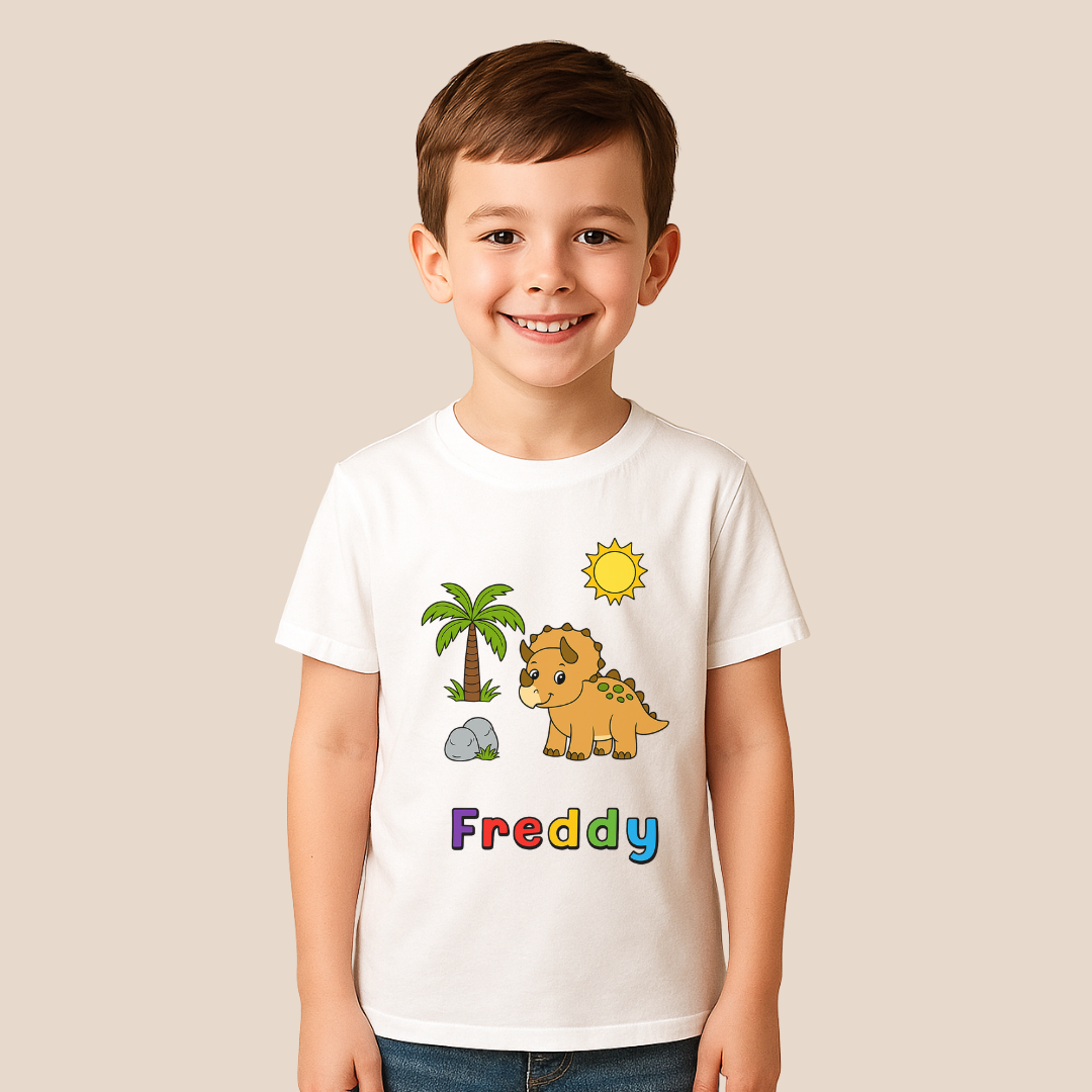 Child wearing a white t-shirt with a dinosaur graphic and the name 'Freddy' on a beige background