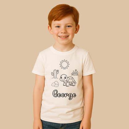 Child wearing a white t-shirt with illustrations and the name 'George' on a beige background