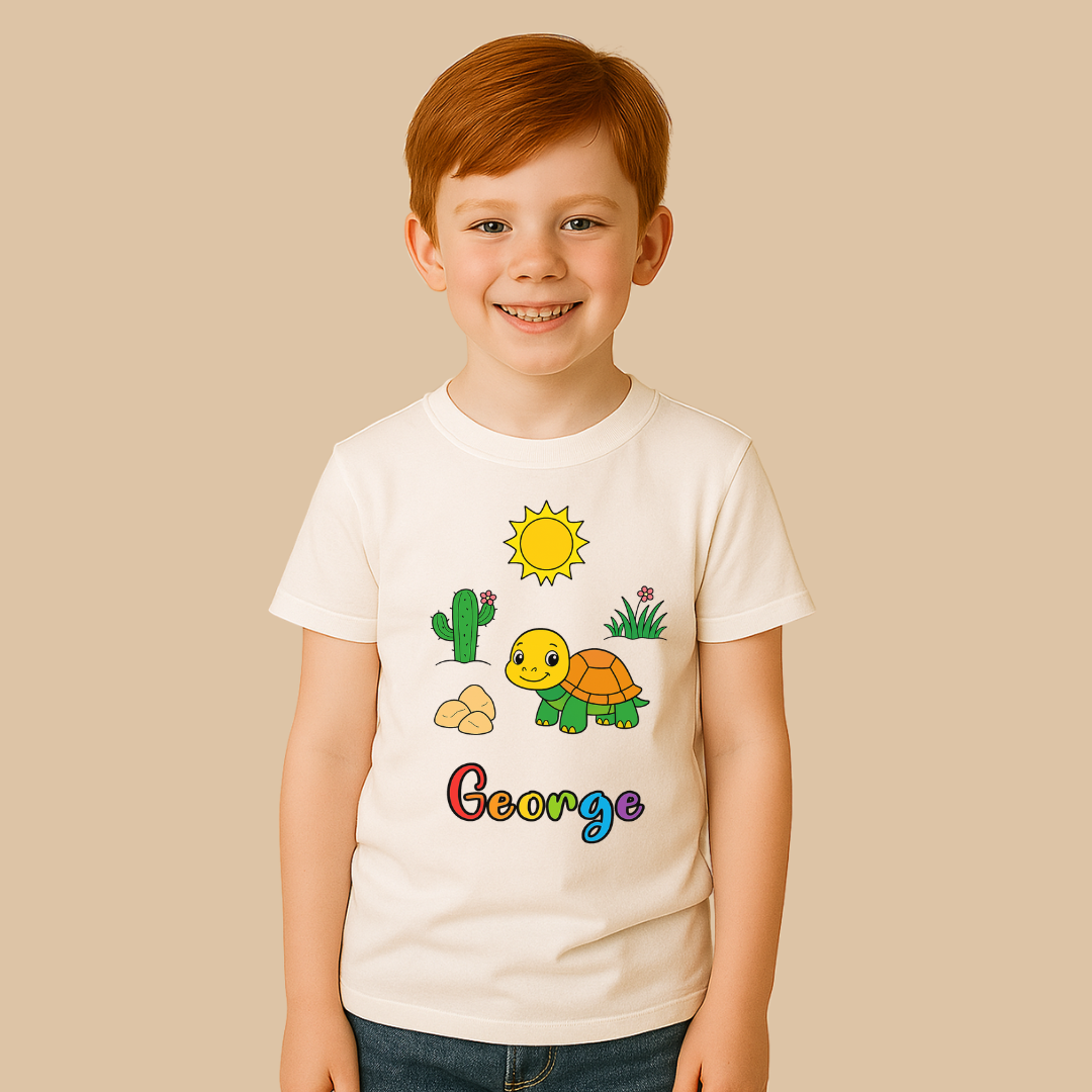 Child wearing a white t-shirt with cartoon turtle design and 'George' text on a beige background