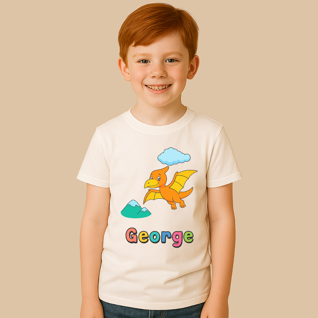 Child wearing a white t-shirt with a cartoon dragon design and the name 'George'.