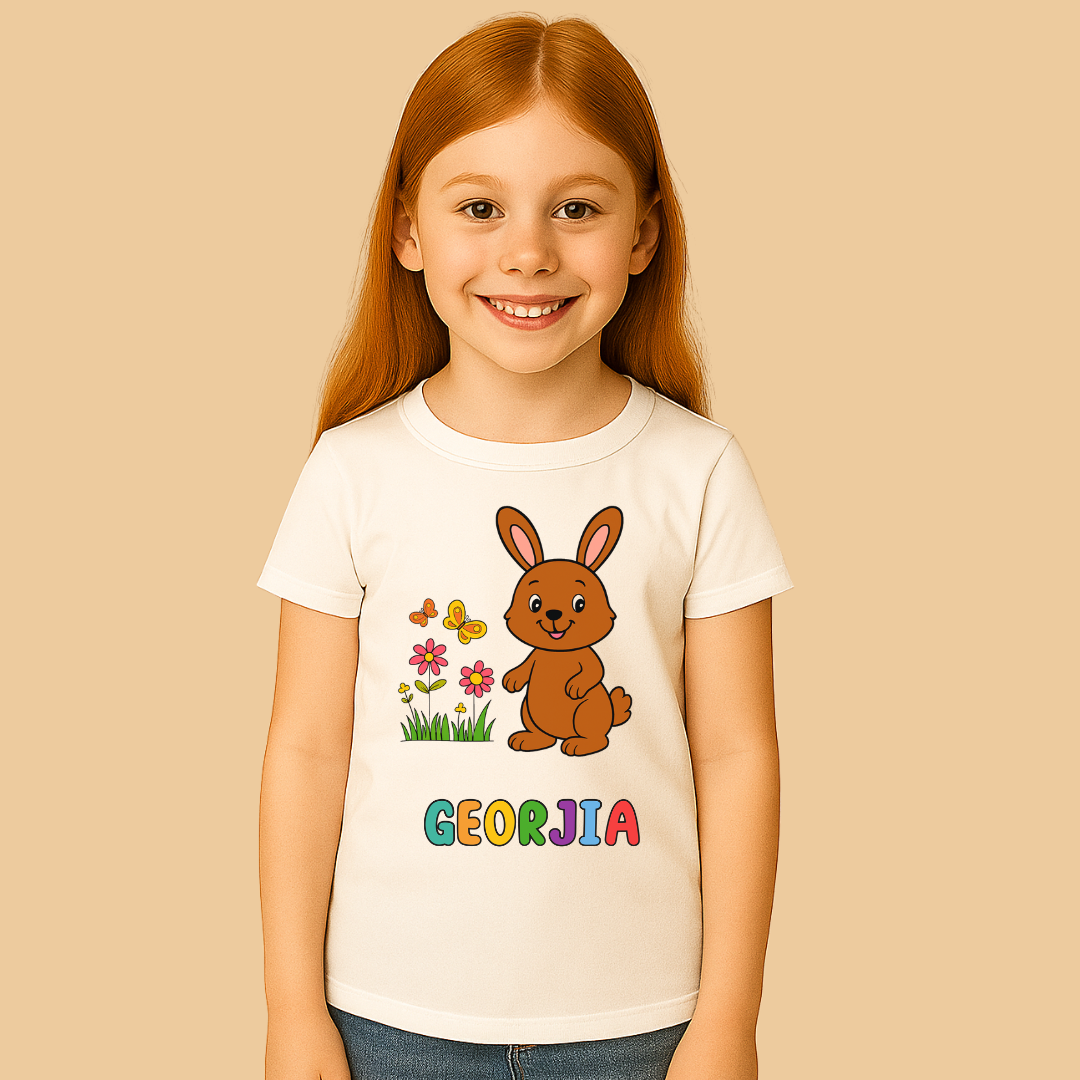 Child wearing a white t-shirt with a cartoon bunny and flowers design on a beige background