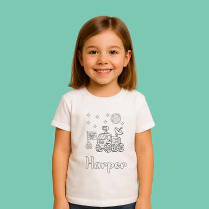 Young girl wearing a white t-shirt with space-themed designs and the name 'Harper' on a teal background
