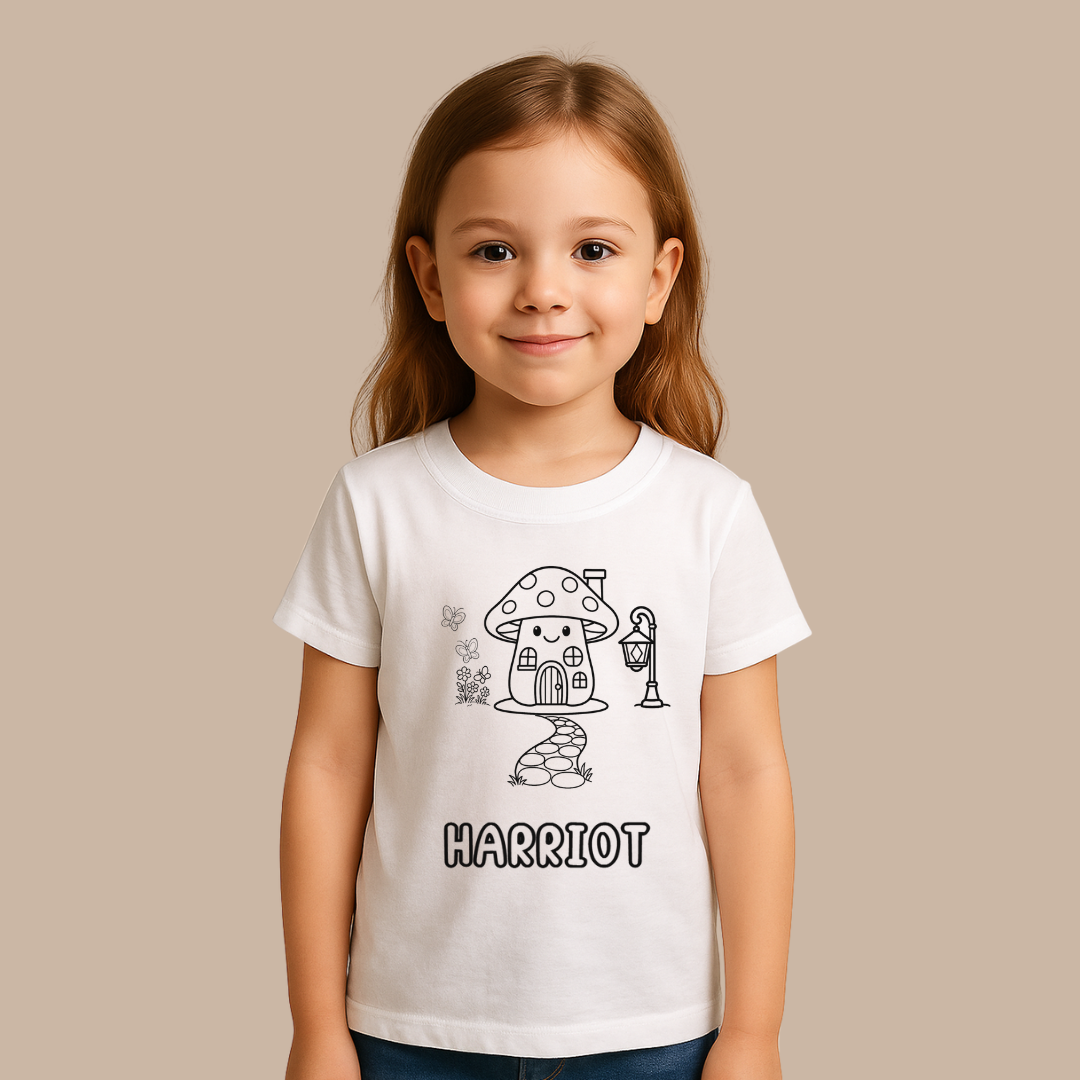 Child wearing a white t-shirt with a mushroom house design and the name 'Harriot'.