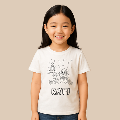 Young girl wearing a white t-shirt with a Christmas design and the name 'KATY'.