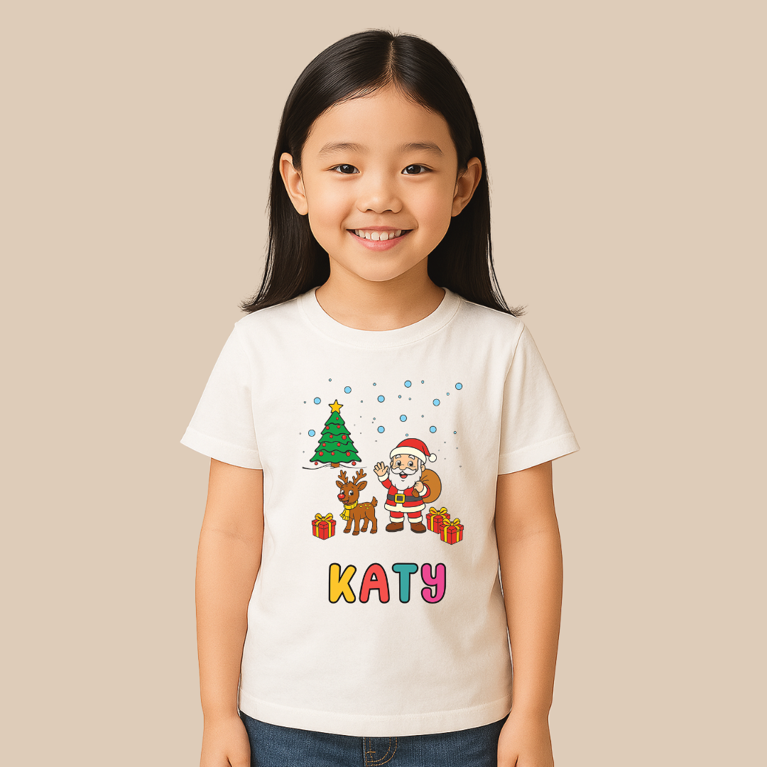 Child wearing a white t-shirt with Christmas-themed design and name 'KATY'.
