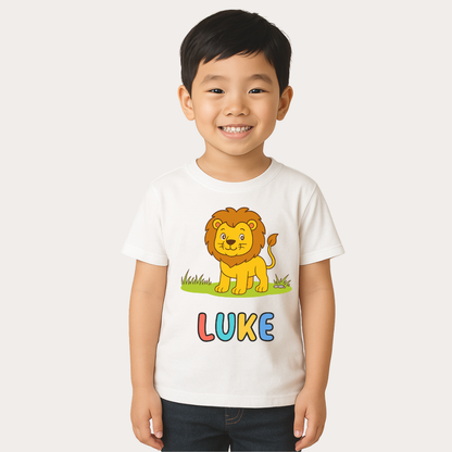 Child wearing a white t-shirt with a cartoon lion and colorful name 'LUKE' on a white background