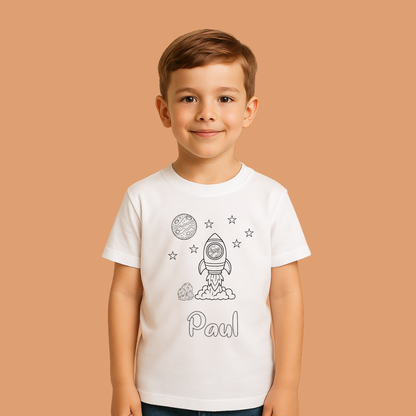 Child wearing a white t-shirt with space-themed graphics and the name 'Paul' on a beige background