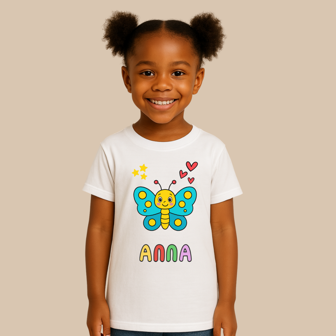 Child wearing a white t-shirt with a colorful butterfly design and the name 'Anna'.
