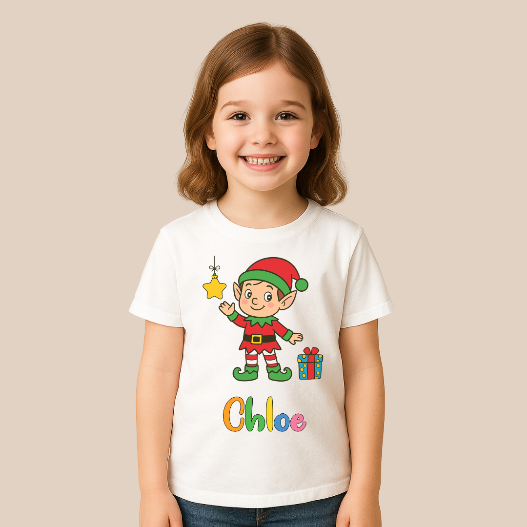 Child wearing a white t-shirt with a Christmas elf design and the name 'Chloe' on a beige background