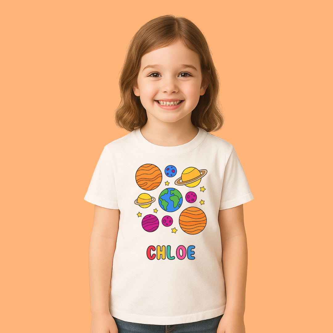Child wearing a white t-shirt with space-themed graphics and the name 'Chloe' on an orange background