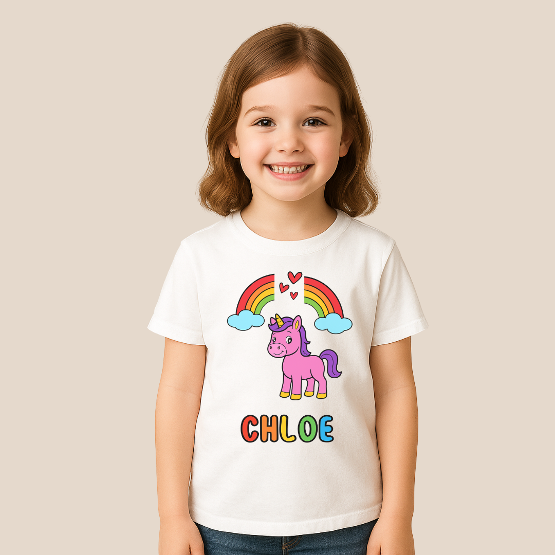 Child wearing a white t-shirt with a unicorn and rainbow design, standing against a plain background.