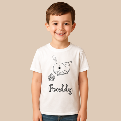 Child wearing a white t-shirt with a whale design and 'Freddy' text on a beige background