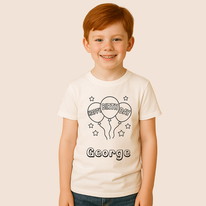 Child wearing a white t-shirt with 'Happy Birthday George' design on a beige background