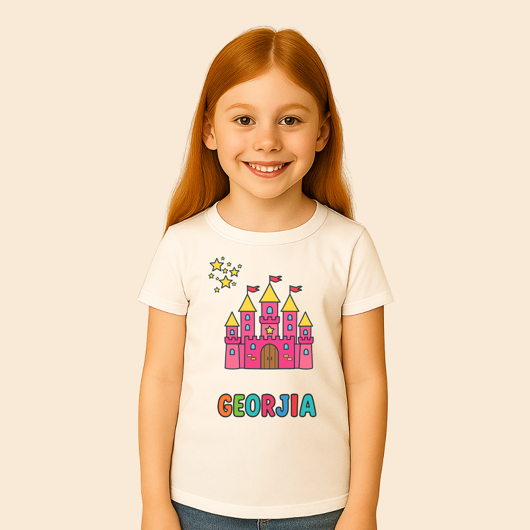 Young girl wearing a white t-shirt with a colorful castle design and 'Georgia' text on a beige background