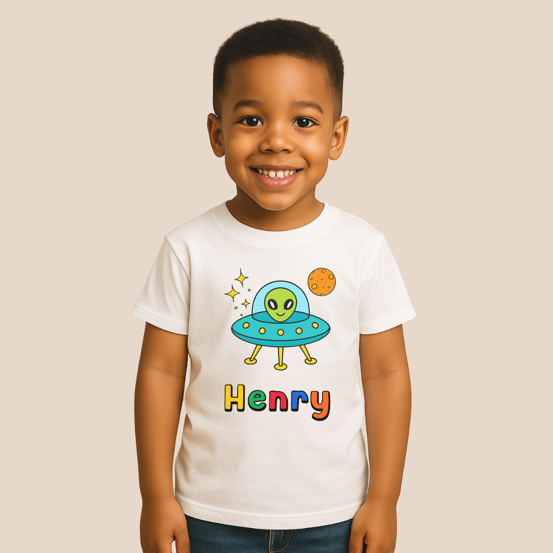 Child wearing a white t-shirt with a colorful alien design and the name 'Henry'.