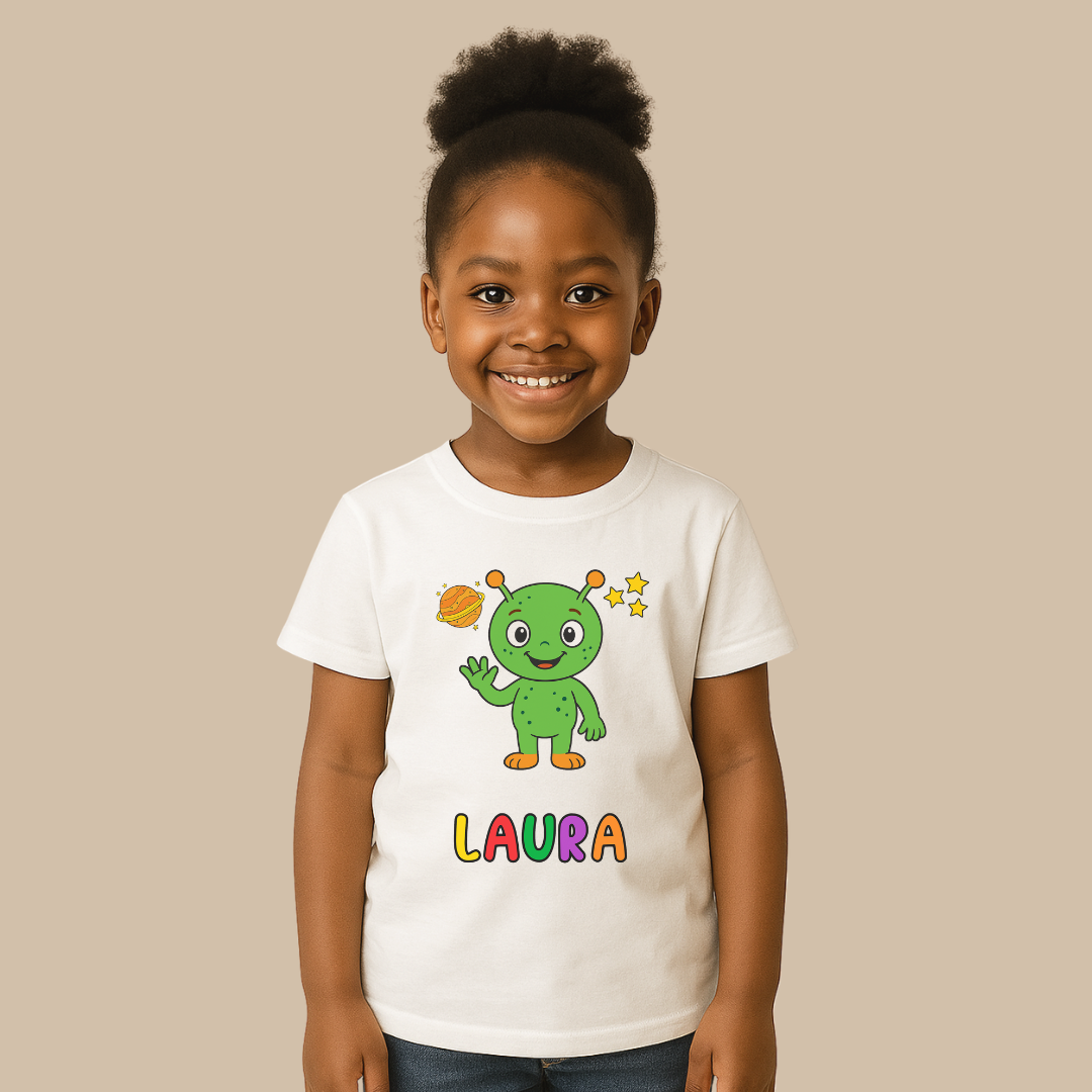 Child wearing a white t-shirt with a green character and 'Laura' text on a beige background