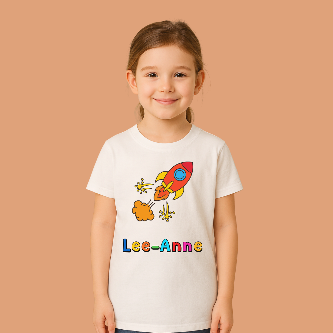Child wearing a white t-shirt with a colorful rocket design and 'Lee-Anne' text on a beige background