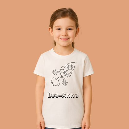 Young girl wearing a white t-shirt with a rocket design and 'Lee-Anne' text on a beige background