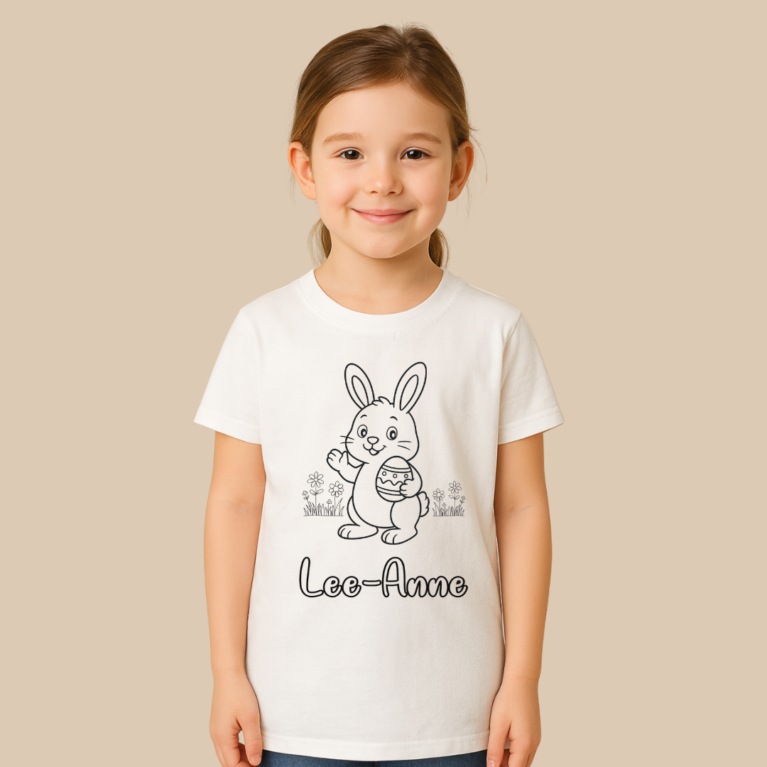 Child wearing a white t-shirt with a printed design and name on a beige background