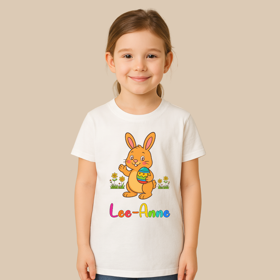 Child wearing a white t-shirt with a colorful bunny design and 'Lee-Anne' text on a beige background