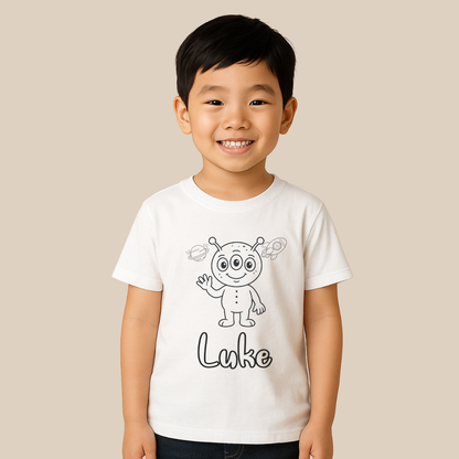 Child wearing a white t-shirt with an alien design and the name 'Luke' on a beige background