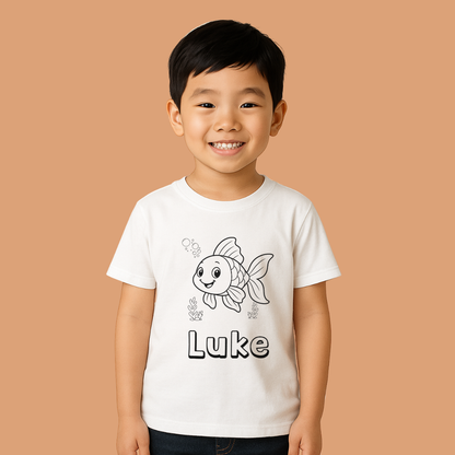 Child wearing a white t-shirt with a fish design and the name 'Luke' on a beige background