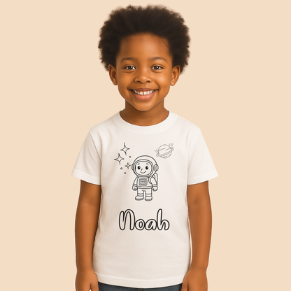 Child wearing a white t-shirt with an astronaut design and the name 'Noah' on a beige background