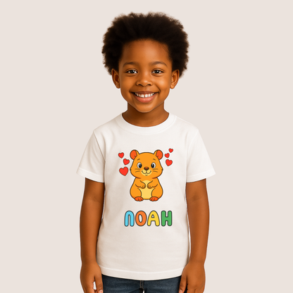 Child wearing a white t-shirt with a cartoon hamster and colorful letters on a beige background