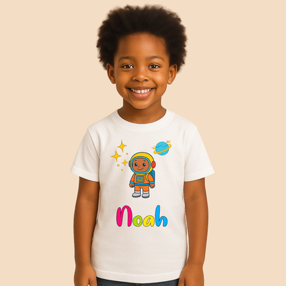 Child wearing a white t-shirt with an astronaut graphic and the name 'Noah' on a beige background