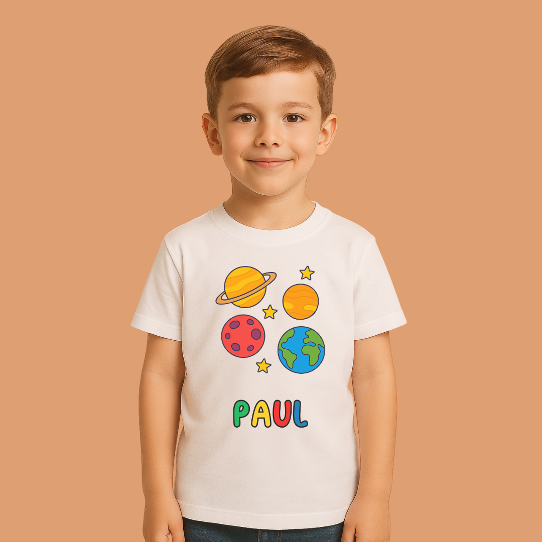 Child wearing a white t-shirt with space-themed graphics and the name 'PAUL' on a beige background