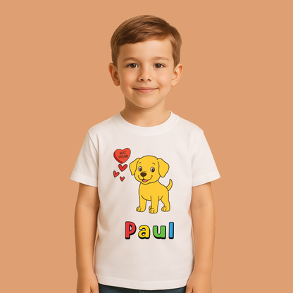 Child wearing a white t-shirt with a yellow dog graphic and 'Paul' text on a beige background