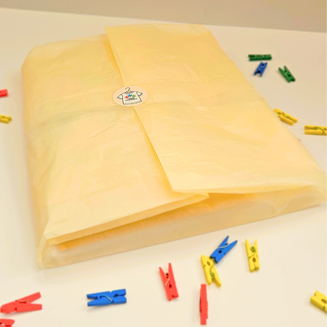 Yellow tissue paper wrapped with colorful clips on a light background 