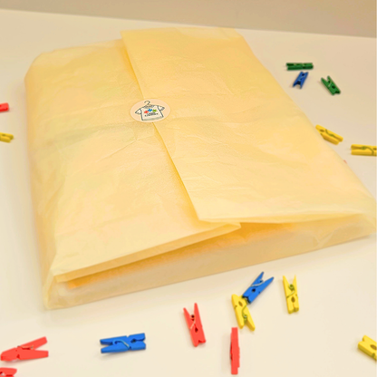 Yellow tissue paper wrapped with colorful clips on a light background 